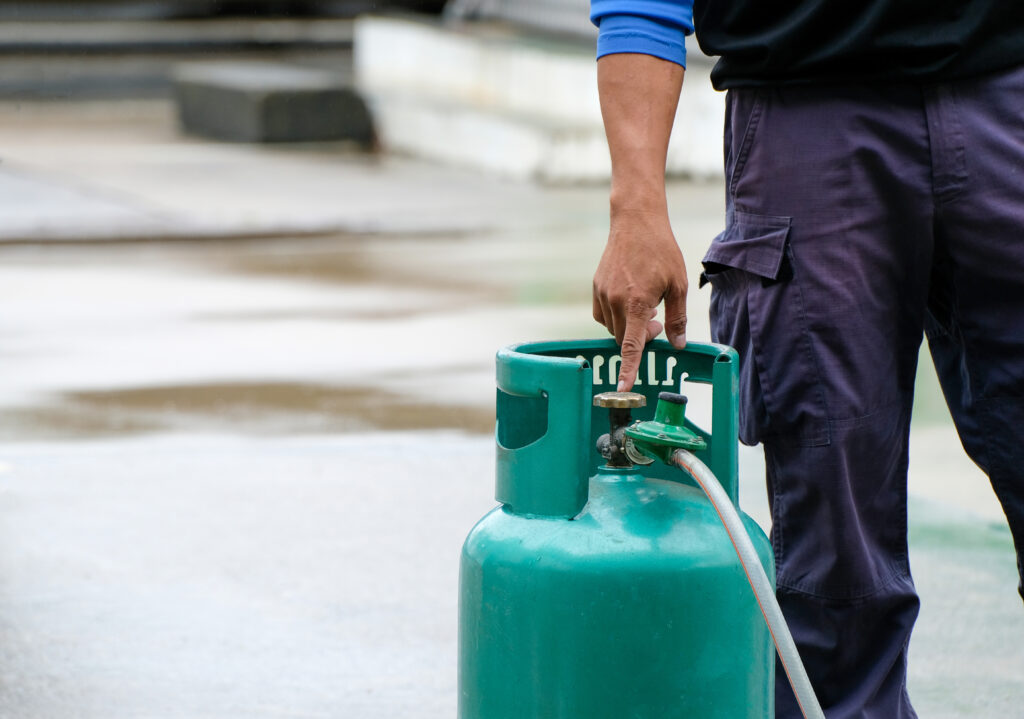 Man s hand pointing lpg gas open valve demonstration fire protection caused by daily use firefighter plans