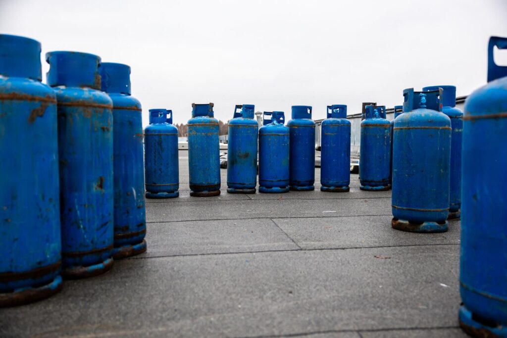 Array used blue propane gas cylinders lined up concrete floor essential supplies industrial welding heating tasks 664057 2926